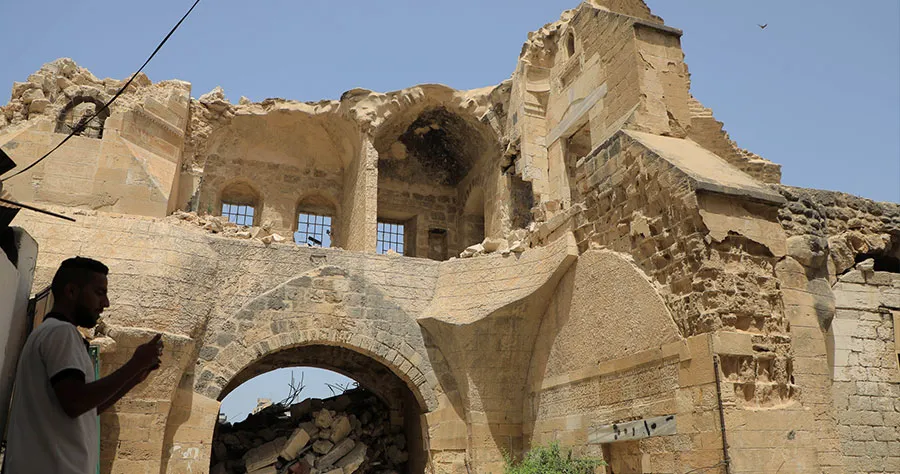 A Palestinian man inspects the historical site of Barquq Castle destroyed in the Gaza conflict - Israel