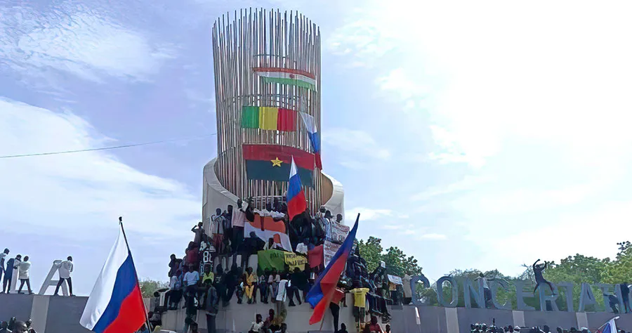 Supporters of Niger’s junta hold Russian flag during a demonstration