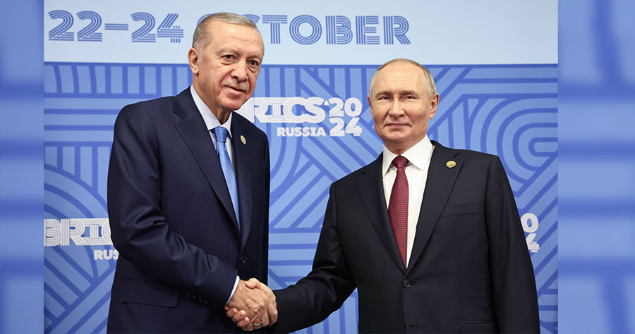 Erdogan and Putin shake hands as they pose for photos before a meeting on the sidelines of the 16th BRICS Summit